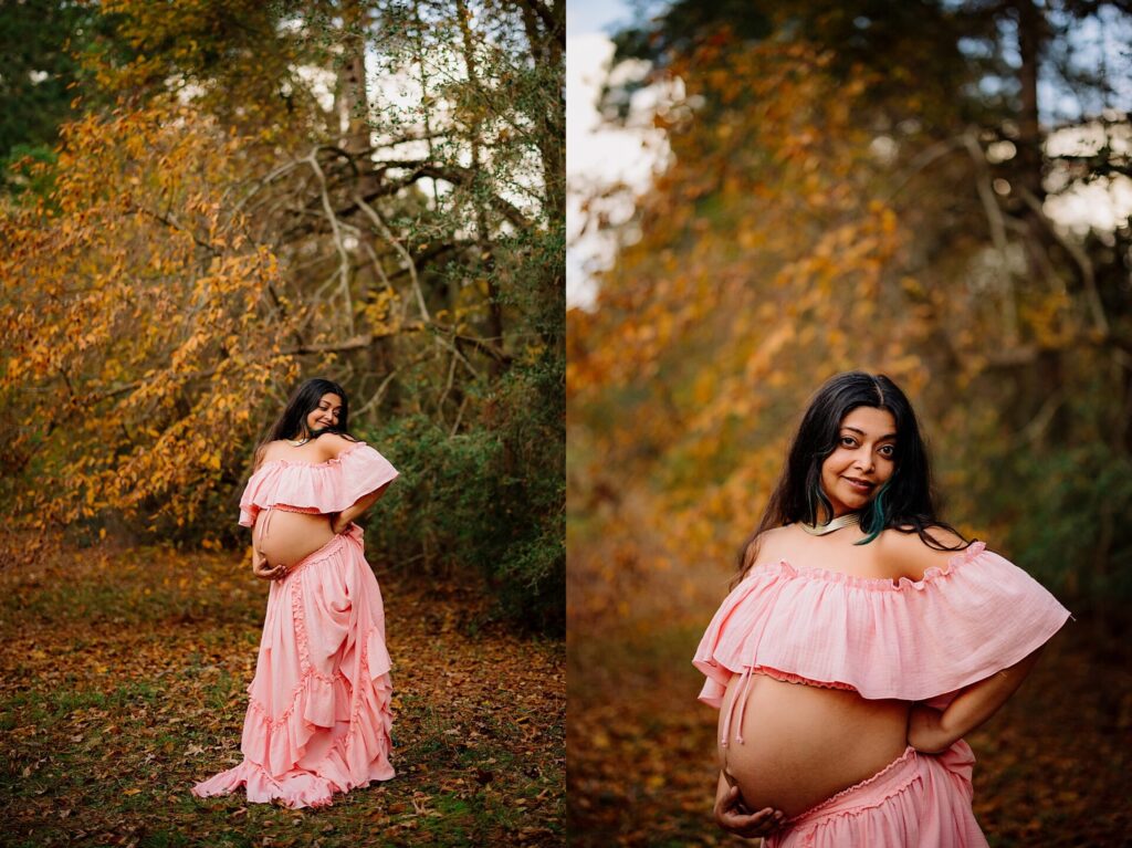 a pregnant mom poses under fall leaves in a pink two piece dress