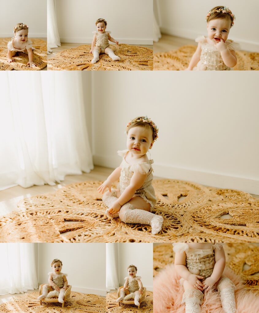 one year old toddler sits on a rug smiling in a lace onesie