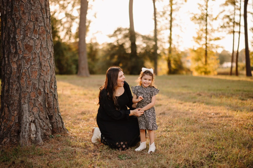 Family outdoor portrait in a park during sunset.