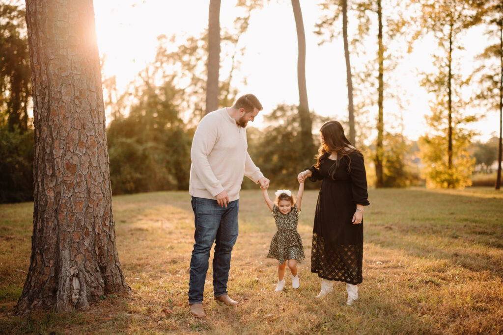 Family outdoor portrait in a park at sunset.