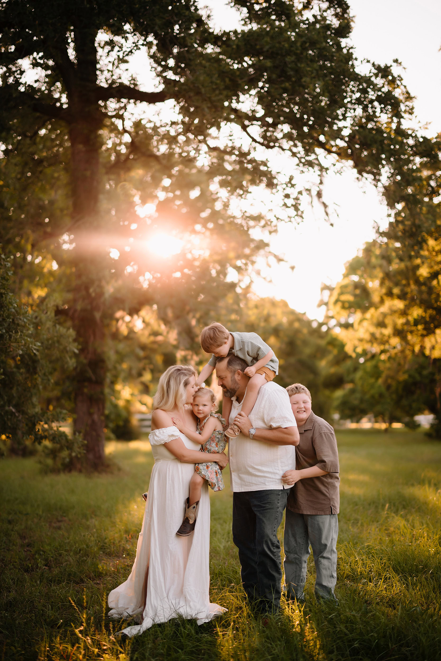 Family enjoying a sunny day outdoors in a lush park setting.