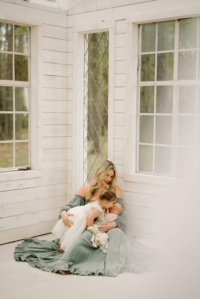 Mother holding her newborn baby, creating a warm and intimate moment.