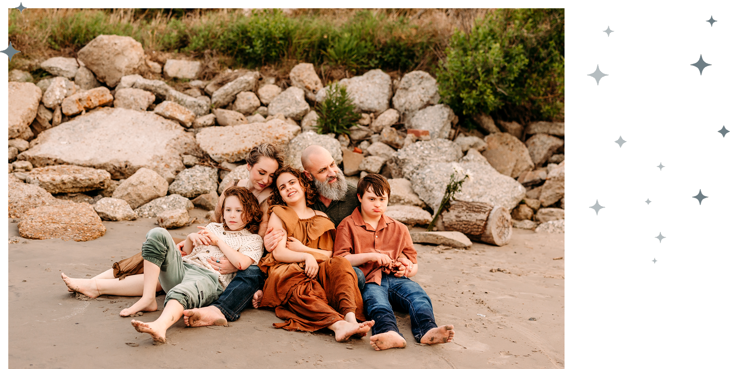 Family portrait on the beach with a grandfather and grandchildren.