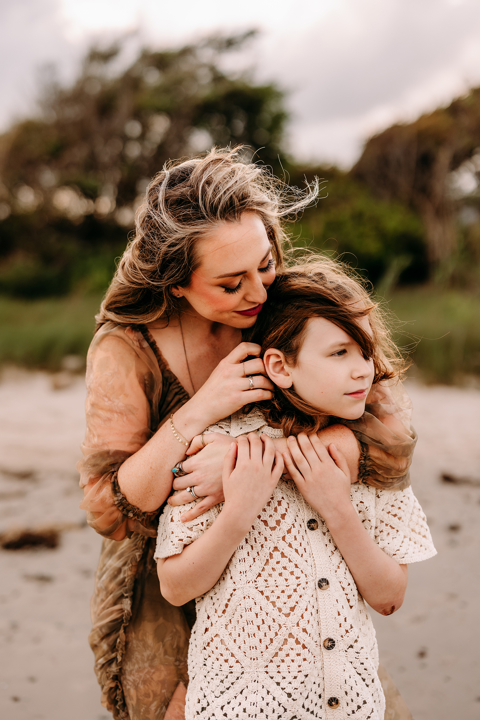 Mother and daughter sharing a tender moment in a natural outdoor setting.
