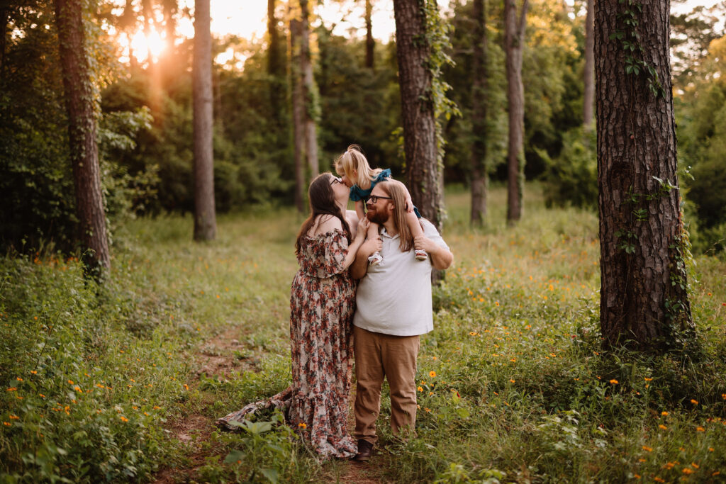 Family enjoying outdoor photoshoot in The Woodlands TX at sunset.