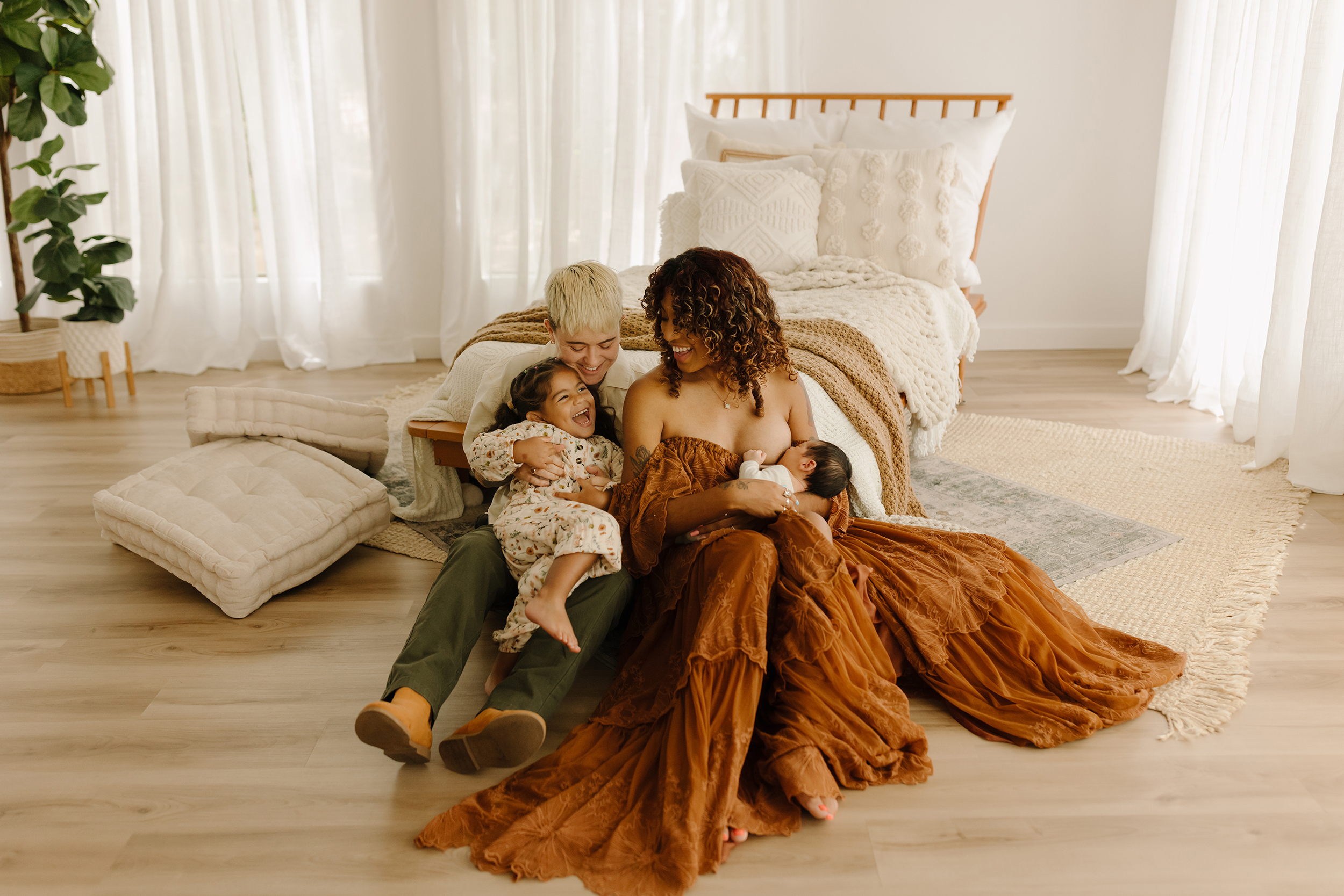 Family with newborn in cozy bedroom in The Woodlands TX.
